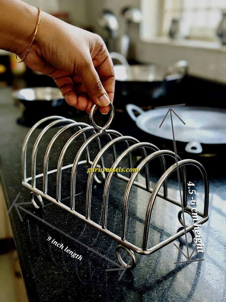 Mini stainless steel plate stand for holding 5, 6 and 7 inch small plates, shown on a white modern kitchen countertop. Another view shows the sturdy mini plate stand on a black South Indian kitchen countertop, with a woman lifting and checking its stability, with kitchen vessels and stove in the background.
